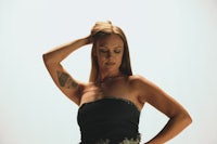 a woman in a black dress posing for a photo