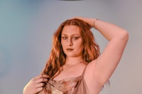 a woman with red hair posing for a photo