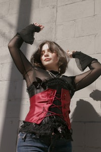a woman wearing a red and black corset